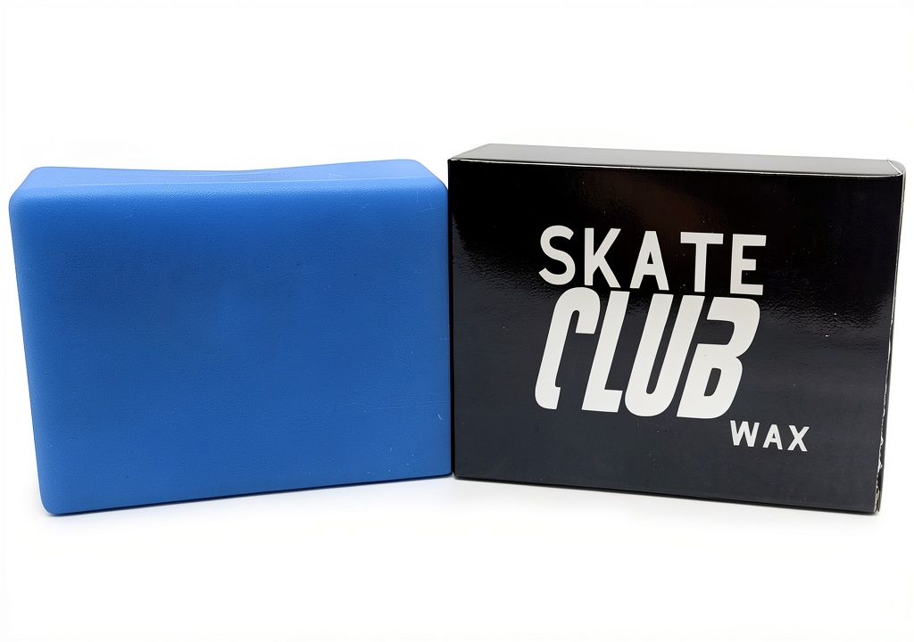 Installing SKATE CLUB WAX Blue Wax on a wooden bench at a skatepark